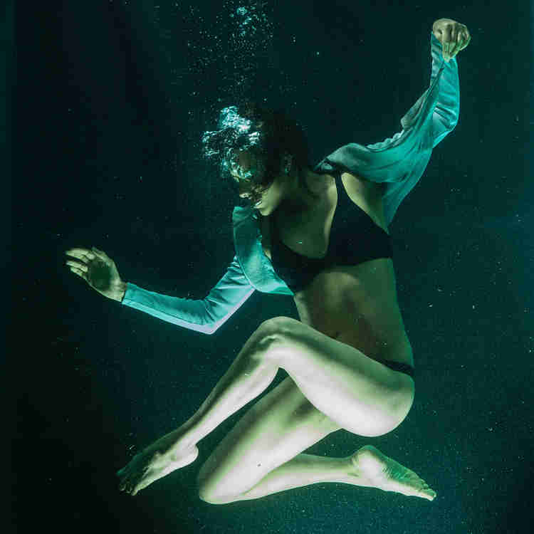 Dance model posing underwater.