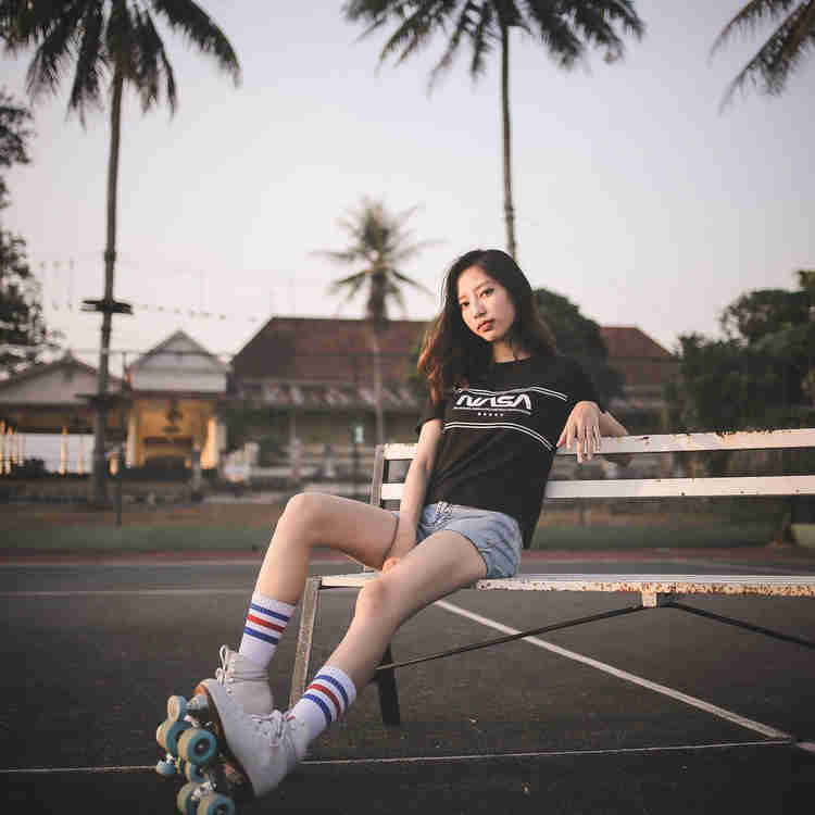 Cool girl rollerblading outside.